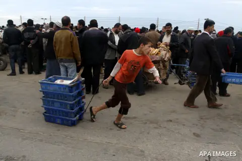 Palestinian men sell fish at a market in Gaza City November 27, 2012. Israel eased restrictions on Gaza fishermen on Saturday, further implementing truce brokered by Egypt after a week of fierce fighting, Palestinian off...