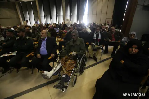 Palestinians listen to the speech of Prime Minister in Gaza strip Ismail Haniyeh during a ceremony to honor the families of martyrs in Gaza city on November 27, 2012. Israeli aircraft killed 166 including scores of civil...