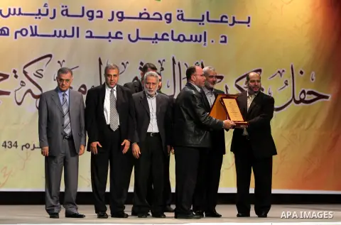 Palestinian Prime Minister in Gaza strip Ismail Haniyeh stands with leaders of Palestinian movements to honors the the families of martyrs in Gaza city on November 27, 2012. Israeli aircraft killed 166 including scores o...