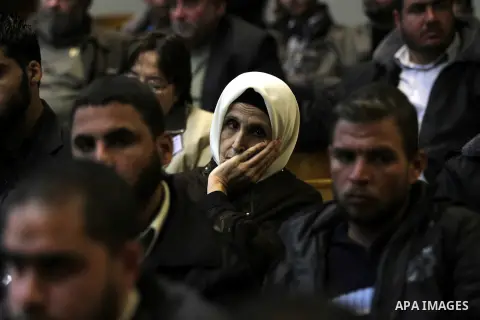 Palestinians listen to the speech of Prime Minister in Gaza strip Ismail Haniyeh during a ceremony to honor the families of martyrs in Gaza city on November 27, 2012. Israeli aircraft killed 166 including scores of civil...