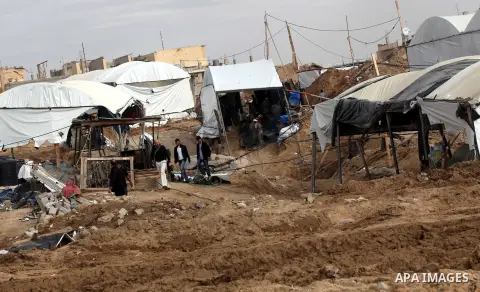 Palestinians work at the entrance of a smuggling tunnels dug beneath the Egyptian-Gaza border in Rafah, in the southern Gaza Strip November 27, 2012. Knee-deep in craters carved out by Israeli air strikes, Palestinians w...