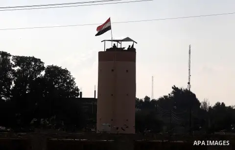 Egyptian border police stand guards on a control tower near the Egyptian-Gaza border in Rafah, in the southern Gaza Strip November 27, 2012. Knee-deep in craters carved out by Israeli air strikes, Palestinians wielded sh...