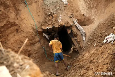 A Palestinian works at the entrance of a smuggling tunnel dug beneath the Egyptian-Gaza border in Rafah, in the southern Gaza Strip November 27, 2012. Knee-deep in craters carved out by Israeli air strikes, Palestinians...