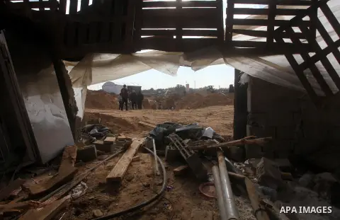 Palestinians work at the entrance of a smuggling tunnels dug beneath the Egyptian-Gaza border in Rafah, in the southern Gaza Strip November 27, 2012. Knee-deep in craters carved out by Israeli air strikes, Palestinians w...