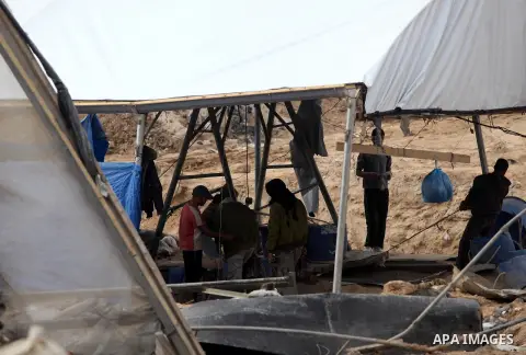 Palestinians work at the entrance of a smuggling tunnels dug beneath the Egyptian-Gaza border in Rafah, in the southern Gaza Strip November 27, 2012. Knee-deep in craters carved out by Israeli air strikes, Palestinians w...