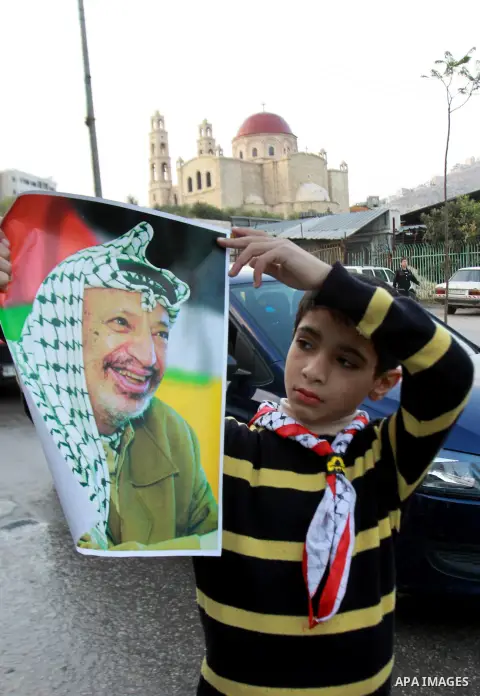 Palestinians children hold pictures of Palestinian President Mahmoud Abbas during a rally to support of requesting membership in the United Nations, in the West Bank city of Nablus on November 27, 2012. The Palestinians...