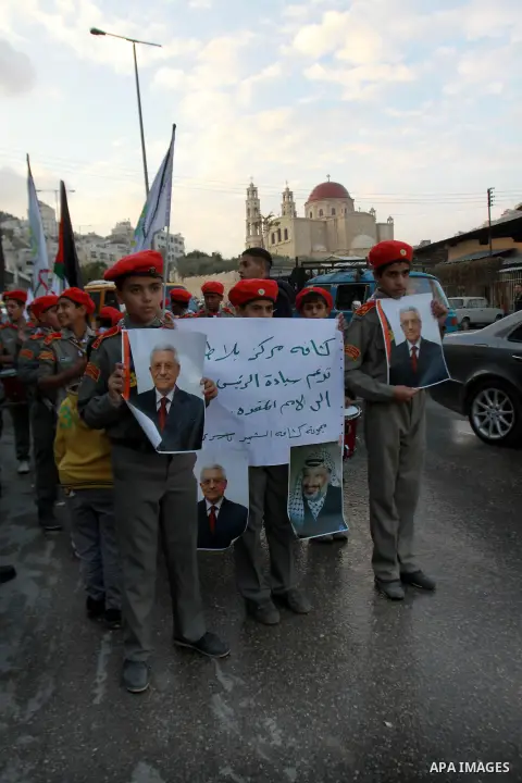 Palestinians children hold pictures of Palestinian President Mahmoud Abbas during a rally to support of requesting membership in the United Nations, in the West Bank city of Nablus on November 27, 2012. The Palestinians...