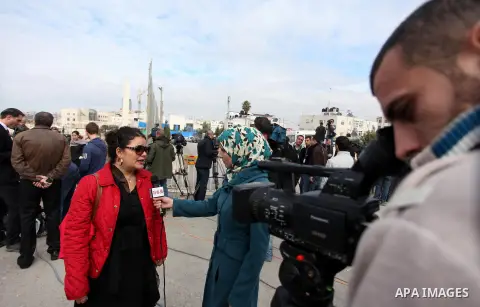 The local and international press gather meters away from the mausoleum of the late Palestinian leader Yasser Arafat, protected by blue tarpaulin on November 27, 2012, at the Muqataa in the West Bank city of Ramallah. Th...