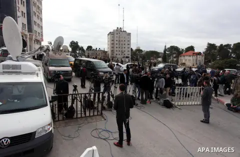 The local and international press gather meters away from the mausoleum of the late Palestinian leader Yasser Arafat, protected by blue tarpaulin on November 27, 2012, at the Muqataa in the West Bank city of Ramallah. Th...