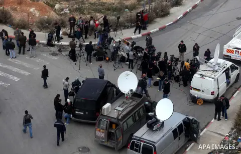 The local and international press gather meters away from the mausoleum of the late Palestinian leader Yasser Arafat, protected by blue tarpaulin on November 27, 2012, at the Muqataa in the West Bank city of Ramallah. Th...
