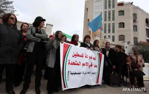 Palestinian women gather in front of U.N. headquarter during a rally to support of requesting membership in the United Nations, in the West Bank city of Ramallah on November 27, 2012. The Palestinians will request to upg...