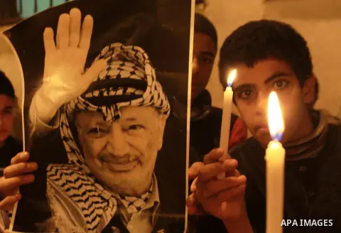 Children hold pictures of President of the Palestine Liberation Organization Mahmoud Abbas and late Palestinian leader Yasser Arafat during a rally at Balata refugee camp near the West Bank city of Nablus, 28 November 20...