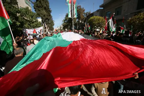 People march with giant Palestinian flags during a rally supporting the Palestinian UN bid for observer state status, in the West Bank city of Hebron, Thursday Nov. 29, 2012. The Palestinians are certain to win U.N. reco...