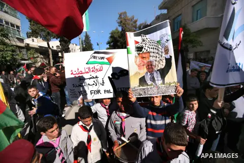 People march with giant Palestinian flags during a rally supporting the Palestinian UN bid for observer state status, in the West Bank city of Hebron, Thursday Nov. 29, 2012. The Palestinians are certain to win U.N. reco...