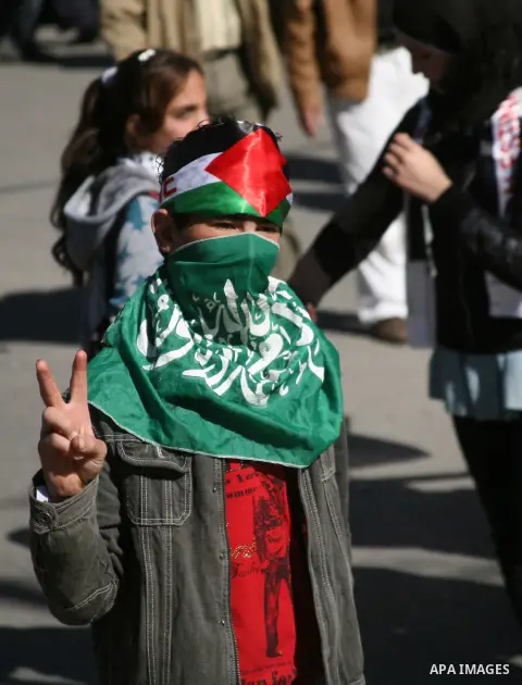 People march with giant Palestinian flags during a rally supporting the Palestinian UN bid for observer state status, in the West Bank city of Hebron, Thursday Nov. 29, 2012. The Palestinians are certain to win U.N. reco...