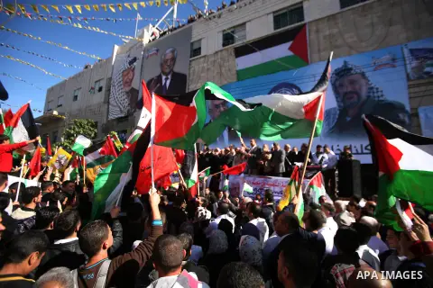 People march with giant Palestinian flags during a rally supporting the Palestinian UN bid for observer state status, in the West Bank city of Hebron, Thursday Nov. 29, 2012. The Palestinians are certain to win U.N. reco...