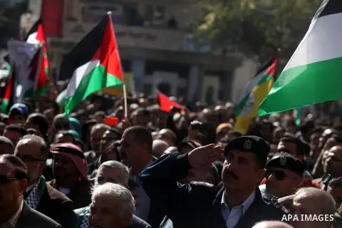 Palestinians wave their national flag during a rally in the West Bank city of Ramallah on November 29, 2012 to support Palestinian leader Mahmud Abbas who is heading to the United Nations General Assembly today with huge...