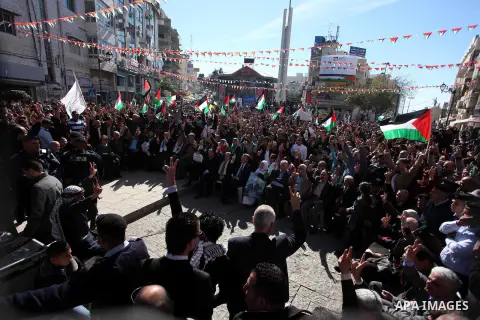 Palestinians wave their national flag during a rally in the West Bank city of Ramallah on November 29, 2012 to support Palestinian leader Mahmud Abbas who is heading to the United Nations General Assembly today with huge...