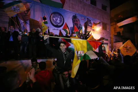 Palestinians celebrate in the West Bank city of Hebron on November 29, 2012 after the General Assembly voted to recognise Palestine as a non-member state. The UN General Assembly on Thursday voted overwhelmingly to recog...