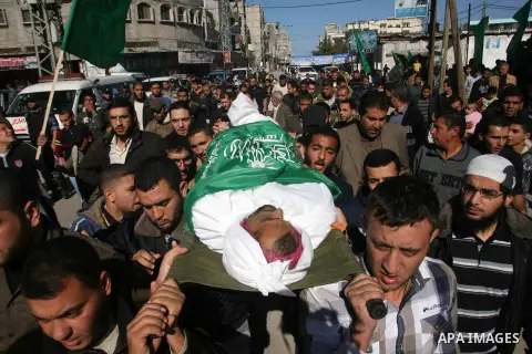Palestinians carry the body of Hussam al-Hams, a member of Hamas' security forces, during his funeral in Rafah, in the southern Gaza Strip November 30, 2012. Al-Hams died on Thursday of a wound he suffered from an Israel...