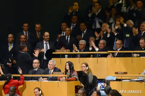 Palestinian President Mahmoud Abbas gets congratulated at the UN General Assembly meeting at the UN headquarters, in New York, November 29, 2012. Abbas appealed to the U.N. General Assembly to recognize Palestinian state...