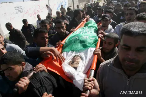 Palestinians carry the body of Mahmoud Jarghoun, 21, during his funeral in the town of Rafah in the southern Gaza Strip on December 1, 2012. One Palestinian died and another was wounded when an Israeli missile fired days...