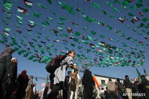 Palestinians gather during the funeral Mahmoud Jarghoun, 21, during his funeral in the town of Rafah in the southern Gaza Strip on December 1, 2012. One Palestinian died and another was wounded when an Israeli missile fi...
