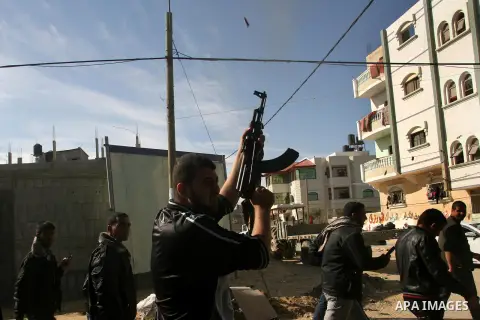 Palestinian relatives mourn over the body of Mahmoud Jarghoun, 21, during his funeral in the town of Rafah in the southern Gaza Strip on December 1, 2012. One Palestinian died and another was wounded when an Israeli miss...