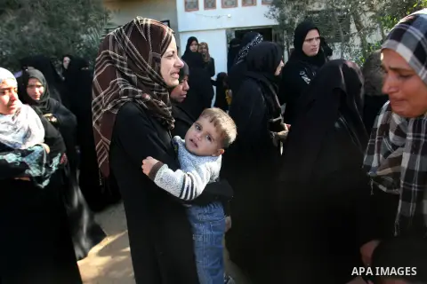 Palestinian relatives mourn over the body of Mahmoud Jarghoun, 21, during his funeral in the town of Rafah in the southern Gaza Strip on December 1, 2012. One Palestinian died and another was wounded when an Israeli miss...