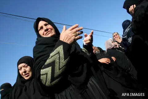 Palestinian relatives mourn over the body of Mahmoud Jarghoun, 21, during his funeral in the town of Rafah in the southern Gaza Strip on December 1, 2012. One Palestinian died and another was wounded when an Israeli miss...