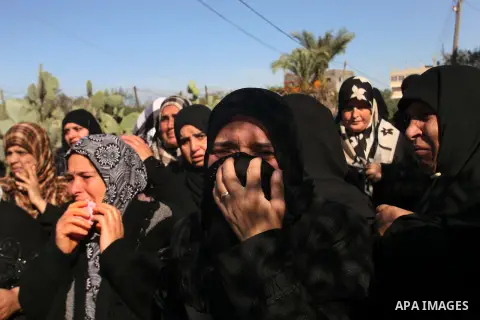 Palestinian relatives mourn over the body of Mahmoud Jarghoun, 21, during his funeral in the town of Rafah in the southern Gaza Strip on December 1, 2012. One Palestinian died and another was wounded when an Israeli miss...