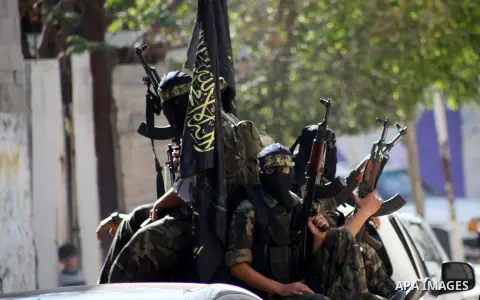 Islamic Jihad militants take part in the funeral of their comrade Ramadan Abu Hassanein during his funeral in Bureij refugee camp in the central Gaza Strip on Dec. 01, 2012. Abu Hassanein died from a wound he suffered fr...