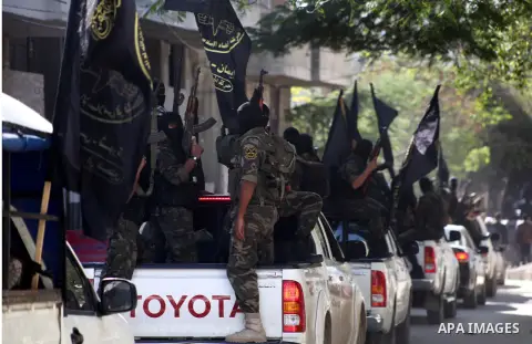Islamic Jihad militants take part in the funeral of their comrade Ramadan Abu Hassanein during his funeral in Bureij refugee camp in the central Gaza Strip on Dec. 01, 2012. Abu Hassanein died from a wound he suffered fr...