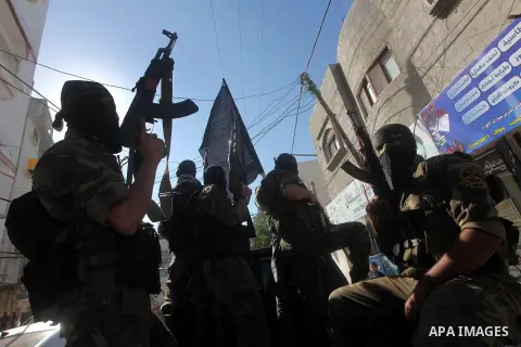 Islamic Jihad militants take part in the funeral of their comrade Ramadan Abu Hassanein during his funeral in Bureij refugee camp in the central Gaza Strip on Dec. 01, 2012. Abu Hassanein died from a wound he suffered fr...