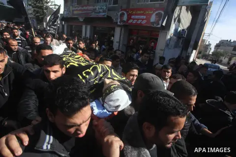 Palestinians carry the body of Islamic Jihad militant Ramadan Abu Hassanein during his funeral in Bureij refugee camp in the central Gaza Strip on Dec. 01, 2012. Shaath died from a wound he suffered from an Israeli air s...