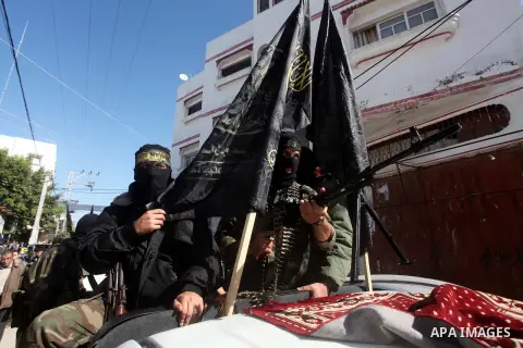 Islamic Jihad militants take part in the funeral of their comrade Ramadan Abu Hassanein during his funeral in Bureij refugee camp in the central Gaza Strip on Dec. 01, 2012. Abu Hassanein died from a wound he suffered fr...
