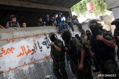 Islamic Jihad militants take part in the funeral of their comrade Ramadan Abu Hassanein during his funeral in Bureij refugee camp in the central Gaza Strip on Dec. 01, 2012. Abu Hassanein died from a wound he suffered fr...