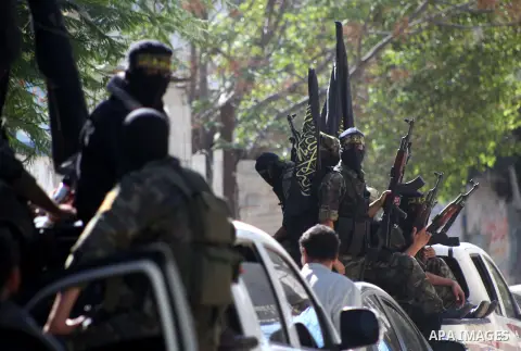 Islamic Jihad militants take part in the funeral of their comrade Ramadan Abu Hassanein during his funeral in Bureij refugee camp in the central Gaza Strip on Dec. 01, 2012. Abu Hassanein died from a wound he suffered fr...