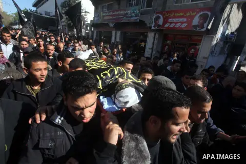 Palestinians carry the body of Islamic Jihad militant Ramadan Abu Hassanein during his funeral in Bureij refugee camp in the central Gaza Strip on Dec. 01, 2012. Shaath died from a wound he suffered from an Israeli air s...