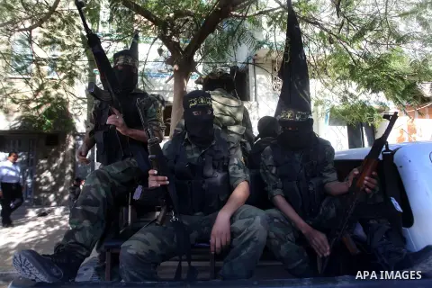 Islamic Jihad militants take part in the funeral of their comrade Ramadan Abu Hassanein during his funeral in Bureij refugee camp in the central Gaza Strip on Dec. 01, 2012. Abu Hassanein died from a wound he suffered fr...