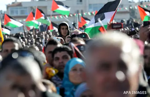 Palestinians wave national flags as they celebrate their successful bid for UN non-member observer state status, in the West Bank city of Ramallah on December 2, 2012, Palestinian President Mahmoud Abbas arrived to the W...