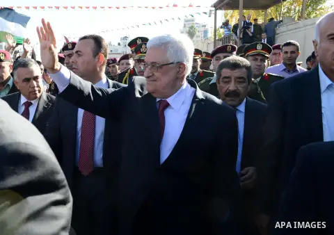 Palestinian President Mahmoud Abbas gestures as Palestinians celebrate their successful bid for UN non-member observer state status, in the West Bank city of Ramallah on December 2, 2012, Abbas arrived to the West Bank a...