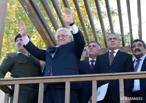 Palestinian President Mahmoud Abbas gestures as Palestinians celebrate their successful bid for UN non-member observer state status, in the West Bank city of Ramallah on December 2, 2012, Abbas arrived to the West Bank a...
