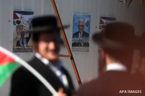 Ultra-Orthodox Jews who oppose zionism wave Palestinian flags as Palestinians celebrate their successful bid for UN non-member observer state status, in the West Bank city of Ramallah on December 2, 2012, Abbas arrived t...