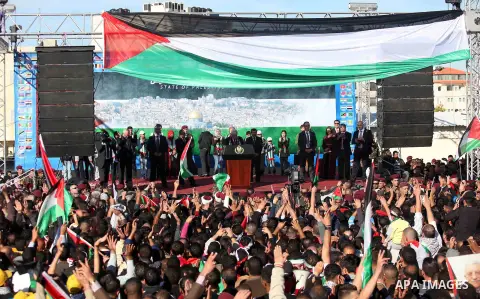 Palestinian President Mahmoud Abbas speaks as Palestinians celebrate their successful bid for UN non-member observer state status, in the West Bank city of Ramallah on December 2, 2012, Abbas arrived to the West Bank aft...