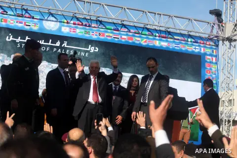 Palestinian President Mahmoud Abbas gestures as Palestinians celebrate their successful bid for UN non-member observer state status, in the West Bank city of Ramallah on December 2, 2012, Abbas arrived to the West Bank a...