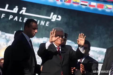Palestinian President Mahmoud Abbas gestures as Palestinians celebrate their successful bid for UN non-member observer state status, in the West Bank city of Ramallah on December 2, 2012, Abbas arrived to the West Bank a...