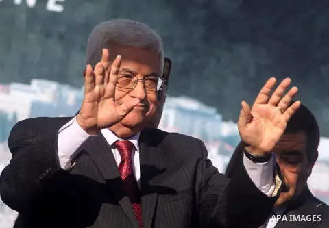 Palestinian President Mahmoud Abbas gestures as Palestinians celebrate their successful bid for UN non-member observer state status, in the West Bank city of Ramallah on December 2, 2012, Abbas arrived to the West Bank a...