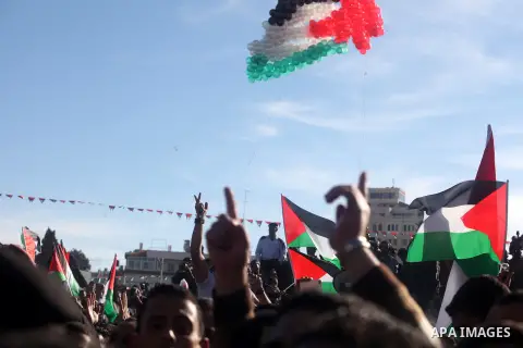 Palestinians wave national flags as they celebrate their successful bid for UN non-member observer state status, in the West Bank city of Ramallah on December 2, 2012, Palestinian President Mahmoud Abbas arrived to the W...