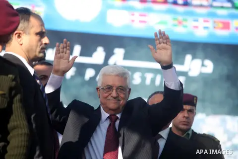 Palestinian President Mahmoud Abbas gestures as Palestinians celebrate their successful bid for UN non-member observer state status, in the West Bank city of Ramallah on December 2, 2012, Abbas arrived to the West Bank a...